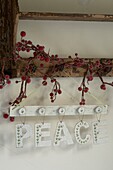 Display of hanging peace Christmas decoration sign