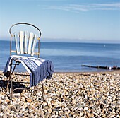 Vintage style chair with blanket on a single beach