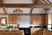 Fitted kitchen with wooden fronts in converted barn