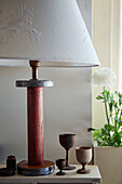 Table lamp with base made of vintage spool and collection of goblets