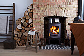 Wood-burning stove in exposed brick chimney in rustic ambience