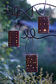 Handmade garden lanterns from old tin cans