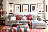 Sofa with throw pillows, a gallery wall with a modern abstract art collection