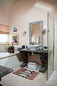 Resin washstand below mirror with mother-of-pearl inlays in bathroom