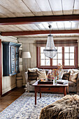 Rustic living room with crystal chandelier and antique furniture