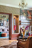 Living room with leopard print wallpaper, band posters and eclectic decoration