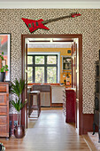 Hallway with leopard print wallpaper and view into the kitchen