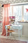 Children's room with desk, chair and cloud wallpaper