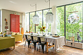 Set dining table, chandelier and view of the greenery