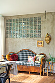 Bench with harlequin pattern, glass block wall and wooden floor