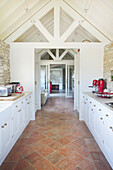 Country kitchen with terracotta tiles and exposed beams