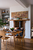 Dining area with wooden furniture and brick fireplace