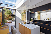 Moderne offene Küche mit Dachfenster und Gartenzugang