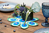 Table centerpiece made from crocheted peacock feathers