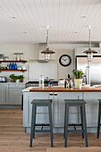 Kitchen island with bar stools and pendant lights