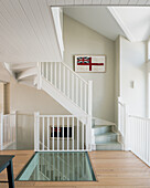 Staircase with glass floor and Union Jack on white wall
