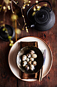Plate with brown cloth napkin and quail eggs