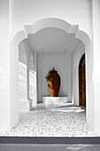 White-painted entryway with terrazzo floor