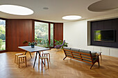 Living area with parquet flooring and circular roof lights