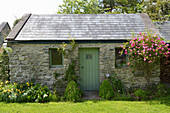 Rural garden house with walls made of fieldstone
