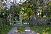 Country house driveway - garden gate with natural stone wall