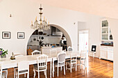 Large dining area with crystal chandelier and passageway to the kitchen