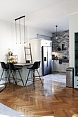 Modern kitchen with bar stools and herringbone parquet flooring