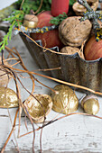 Gilded walnuts and acorns in front of a baking tin