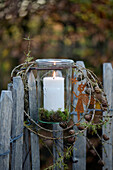Weck jar as a lantern on a wooden fence