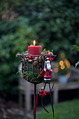 Christmas candle decoration in a wire basket