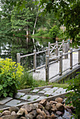 Garden pond with wooden footbridge