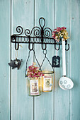Homemade lanterns with nostalgic photos hanging on a rack of hooks