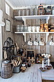 Open shelves in rustic kitchen with wood paneling