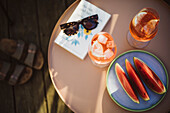 Aperol Spritz and watermelon slices on tray top table