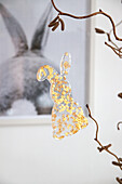 DIY-pendant with melting granules on corkscrew branches as Easter decoration
