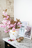 DIY Kintsugi vase (Japanese ceramic art) with pink blossom branches