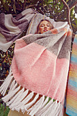 Young woman with striped blankets (mohair and alpaca)