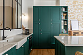 Kitchen island with petrol-colored cabinet fronts