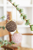 Larch branch decorated with crocheted Christmas baubles