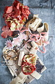 Artificial flowers, fabric ribbons, and pearl necklace
