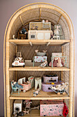 Vintage wicker shelf with doll house furniture