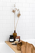 Bath shelf with brown accessories, white subway tiles on the wall
