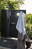 Outdoor shower with wooden shower wall