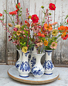 Bouquet of carnation root (Geum) in ceramic vases