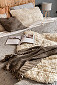 Animal fur and blanket on queen bed