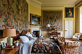 Tapestries and floral ceiling in the bedroom of a 17th century English country house