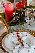 Christmas place setting decorated with a holly branch