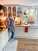 Woman with mulled wine in a farmhouse style kitchen