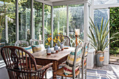 Antique cherry wood dining table with chairs in the conservatory
