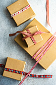 Vintage gift boxes with red and white ribbons on concrete background